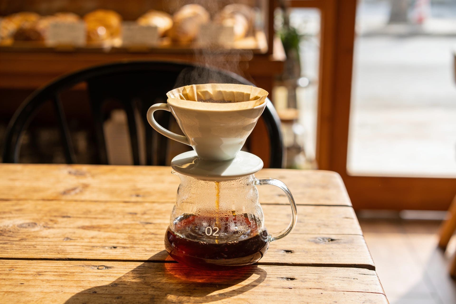 A slow pour-over filter coffee brewing on the bar